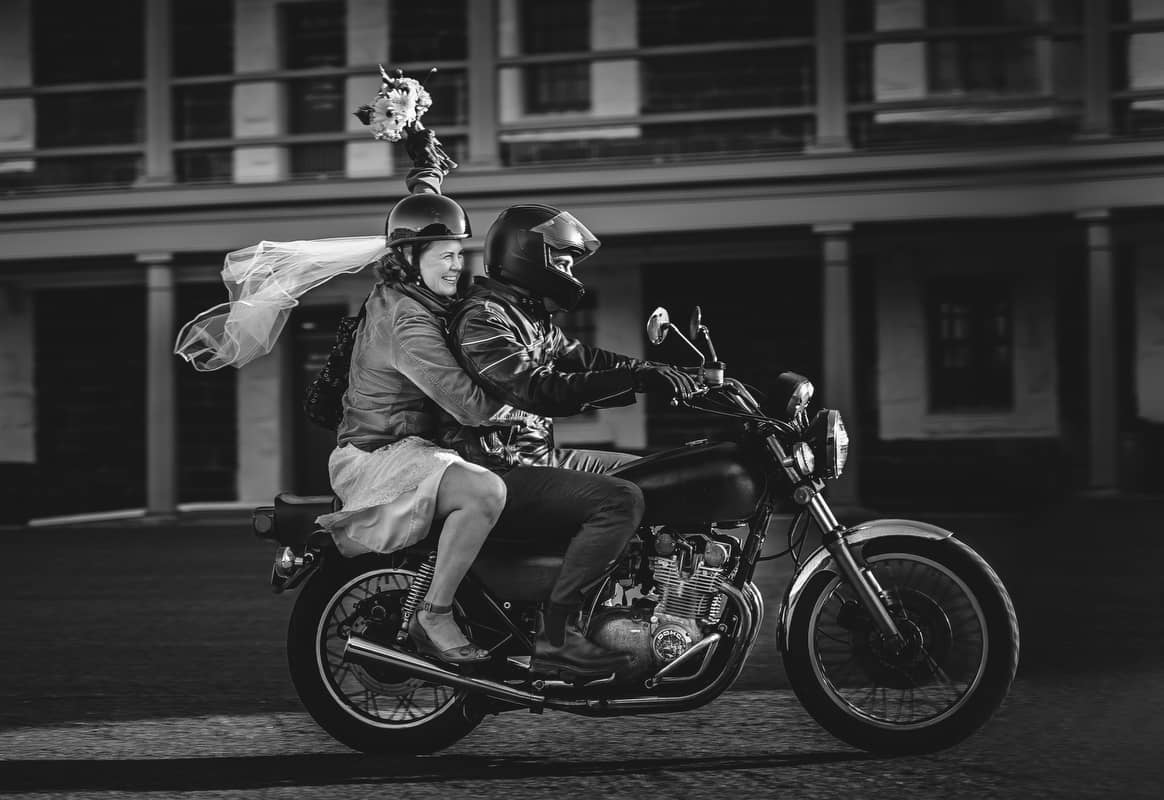 bride and groom riding a motor cycle at a halifax wedding